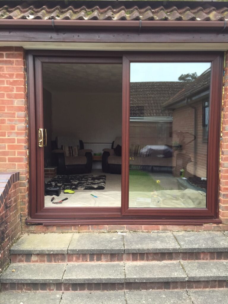 Open brown patio sliding doors in front of steps