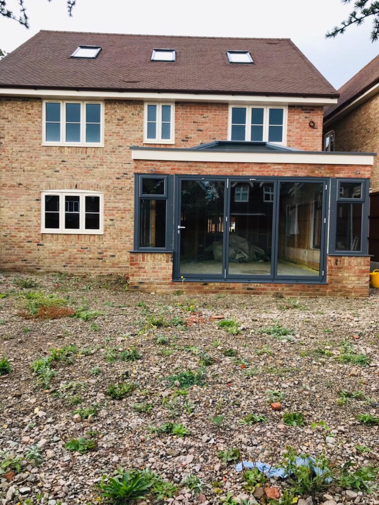 triple panel aluminium bi fold doors leading to a patio