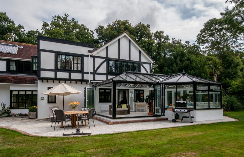 view of a modern/tudor themed home from the garden which has had newly installed windows