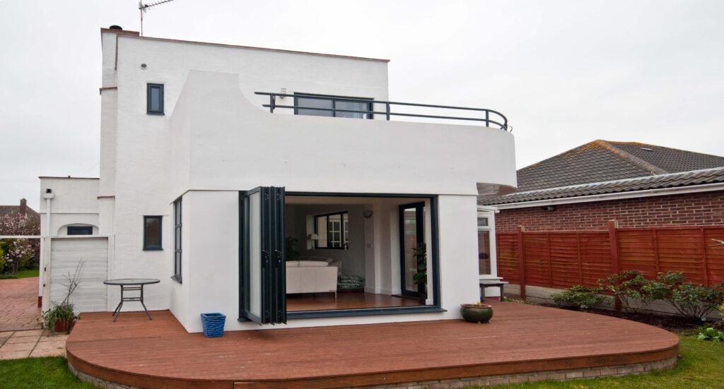 modern art deco building with open grey bifolding doors