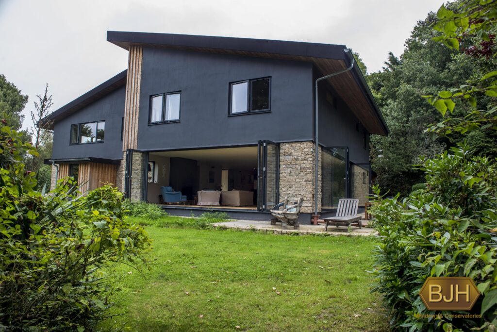 exterior of open bi-folding doors leading to a green garden
