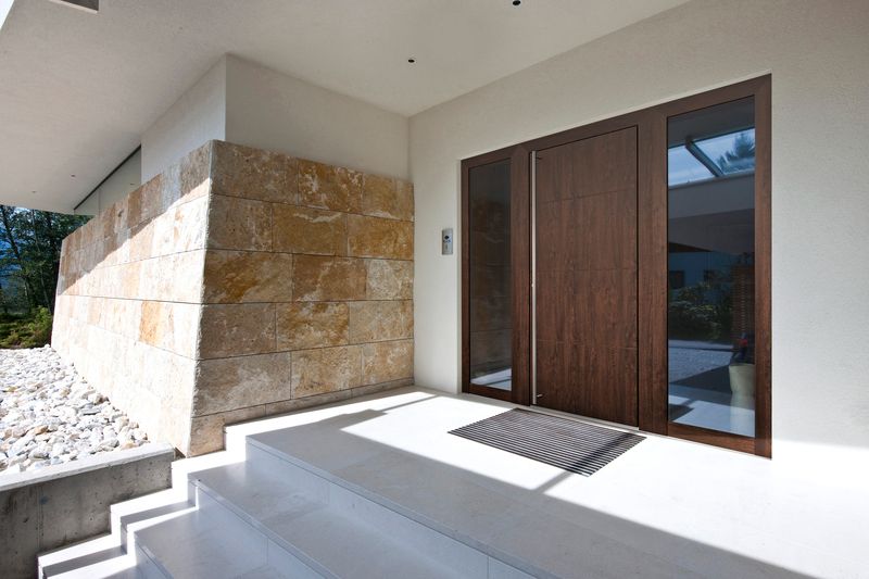 brown internorm front door on a modern porch