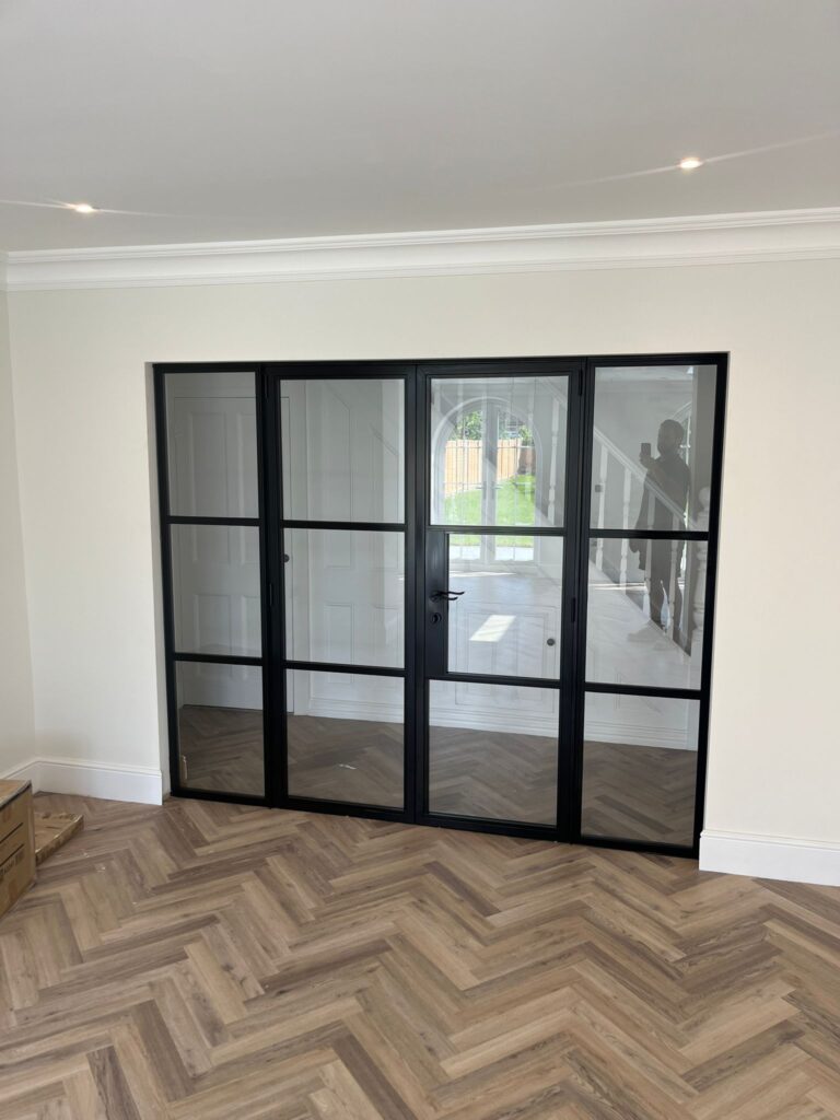 glass door with a black frame that has been recently installed inside someones home