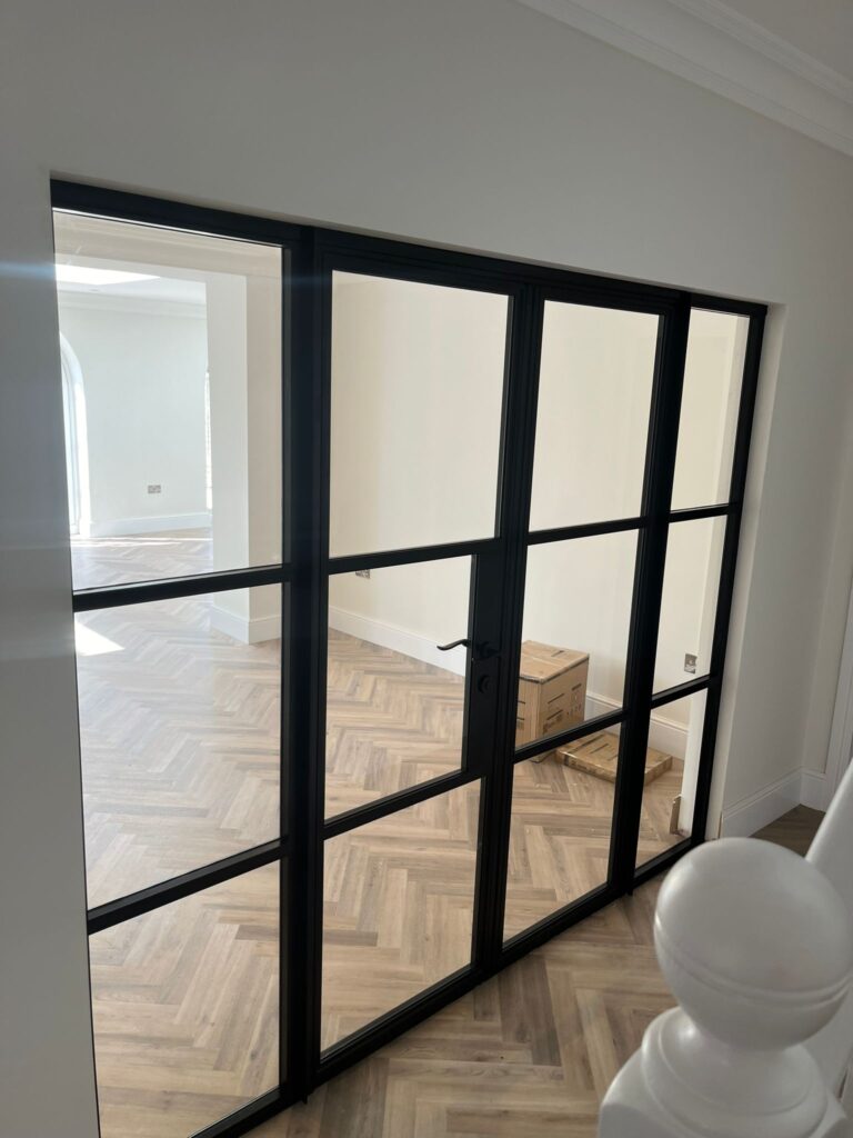 glass door with a black frame that has been recently installed inside someones home