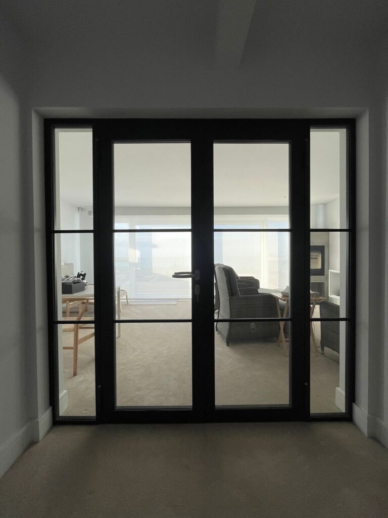 glass door with a black frame that has been recently installed inside someones home