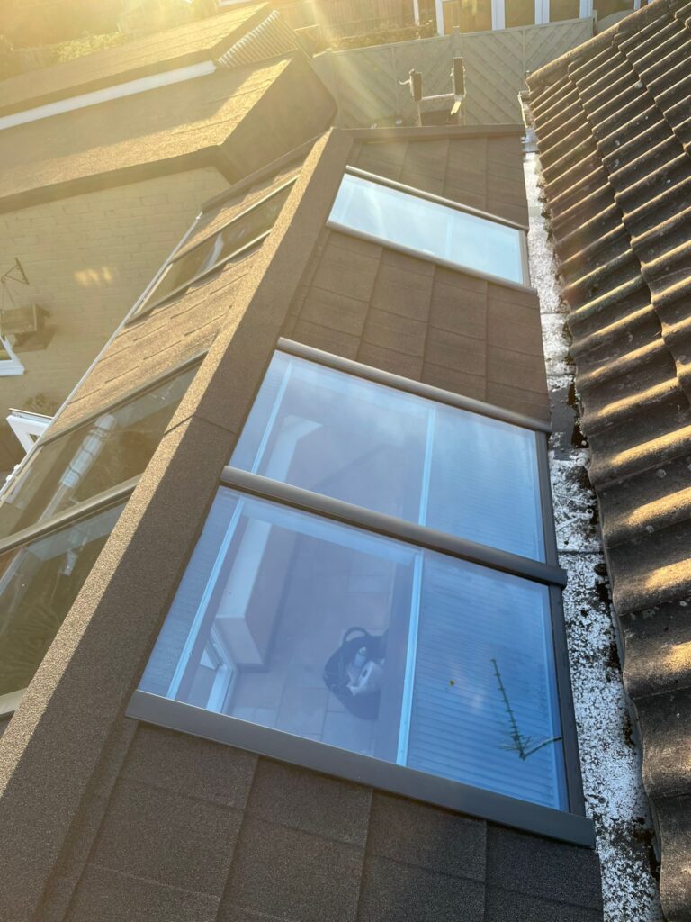 view looking down at a roof with some sky view windows on it
